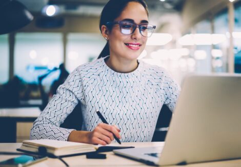Woman with glasses working on a computer - director of finance