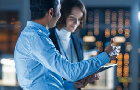 Man and woman looking at documents senior customer delivery manager Lead Product Manager