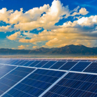 Image of sunrise over a field of solar panels. 2019 PV Systems Symposium